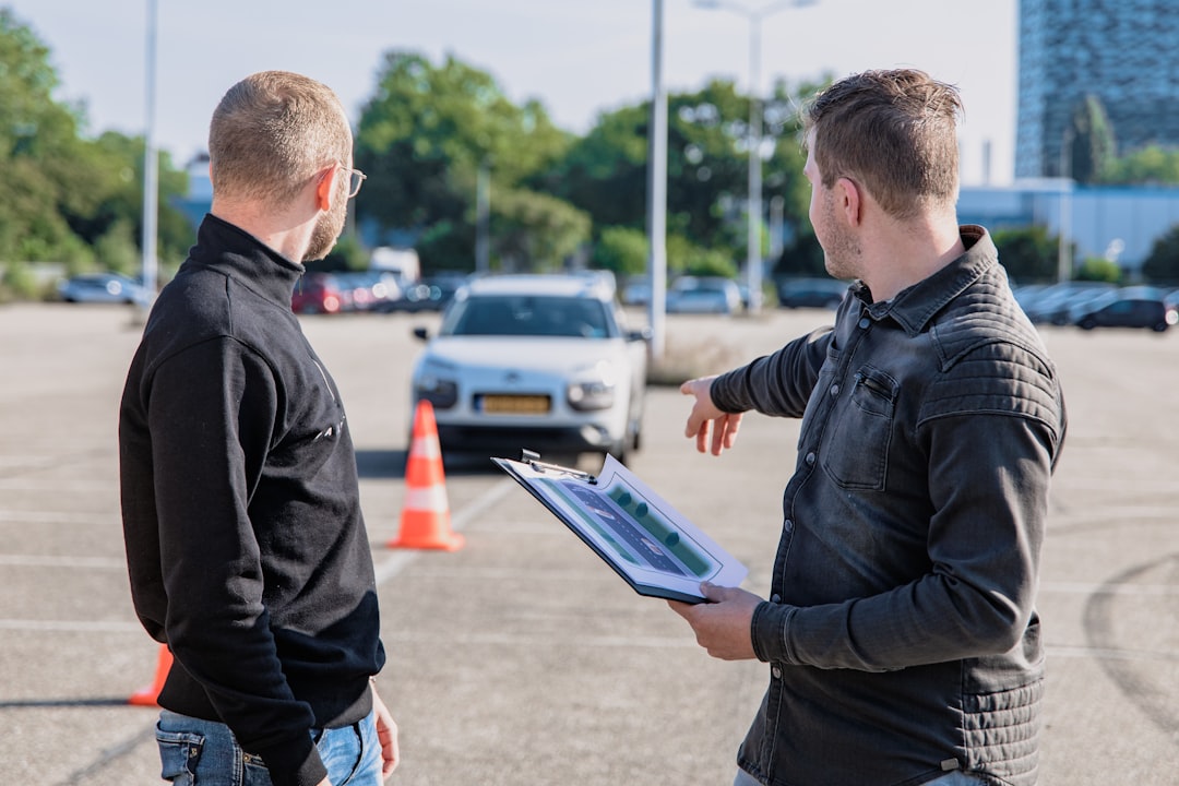 why-choose-us Driving instructor explaining to a student with trafic cone